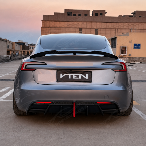 High-gloss black SuperAutoUSA VTEN rear diffuser providing sharp lower contrast on a Pearl White Tesla Model 3