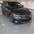 Full front 3/4 perspective of a 2024 BMW M340i featuring the SuperAutoUSA gloss black front splitter