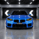 Gloss black SuperAutoUSA VTEN front canards providing sharp contrast on a Zandvoort Blue BMW M2