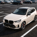 BMW X3 G45 with new SuperAutoUSA gloss black front lip parked in a detailing studio