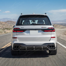 2023 BMW X7 in motion highlighting the aggressive real carbon fiber rear aerodynamics