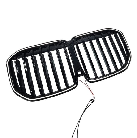 Direct front view of the SuperAutoUSA LCI-style gloss black illuminated grille for 2023-2026 BMW X7