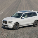 Full 3/4 view of a 2024 BMW X7 M60i featuring the double real carbon fiber lip kit