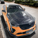 Cadillac CT4 in showroom with a SuperAutoUSA hood
