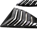 2014 Chevrolet Camaro in motion featuring the aggressive gloss black louver