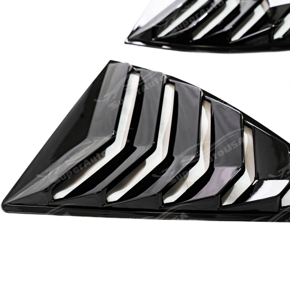 2014 Chevrolet Camaro in motion featuring the aggressive gloss black louver