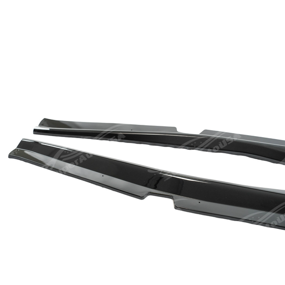 Gloss black Z06 style side skirt rocker panels on a white Corvette C7