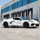 High-contrast exotic carbon fiber side skirts accenting an Arctic White C8 Corvette Stingray