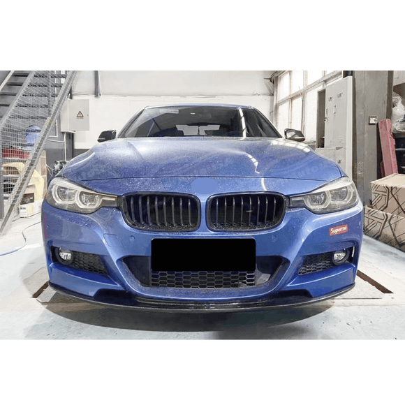 Low angle perspective of the Fits BMW 2012-2019 3-Series F30 M Sport with Auto Plus Style Gloss Black Front Lip Spoiler, accentuating the car's sporty stance