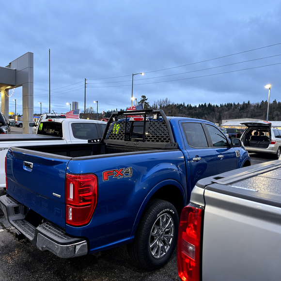 Direct rear view showing high-mounted LED chase lights and rear cab window protection screen
