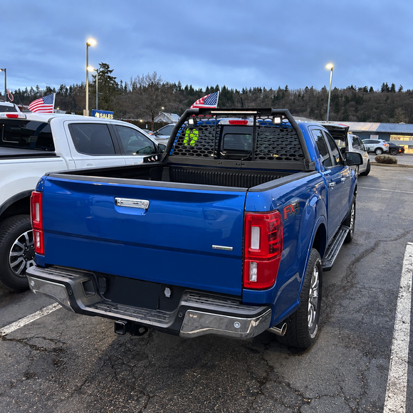 Industrial-grade steel roll bar headache rack installed on a lifted Ford F-250 Super Duty