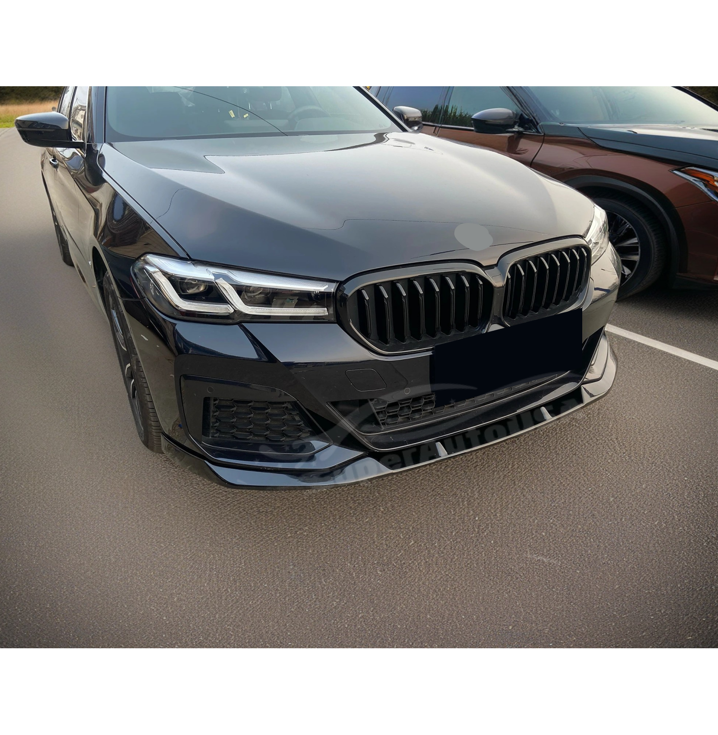 Close-up of the Fit 2021-2024 BMW 5 Series G30 Gloss Black Front Bumper Lip Spoiler, emphasizing the front spoiler lip splitter's sleek design.