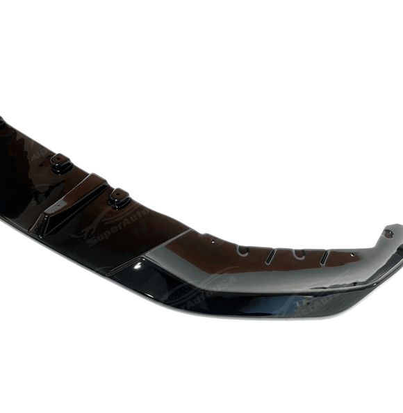 Dynamic view of the BMW 5 Series G30 equipped with a gloss black front splitter spoiler lip, showcasing its stylish and aggressive stance.