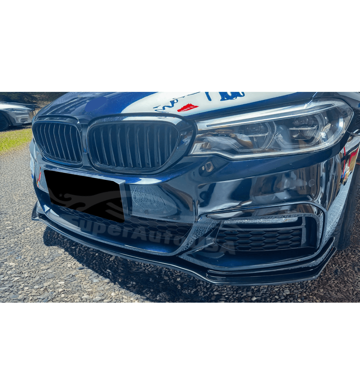 Front angle shot of the Fit 2017-2020 BMW 5 Series G30 LCI M Sport with its Gloss Black Front Bumper Lip Spoiler, emphasizing the front spoiler lip splitter's aggressive design.