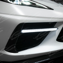 Carbon fiber sequential LED DRL light bar bezel insert on a white C8 Corvette