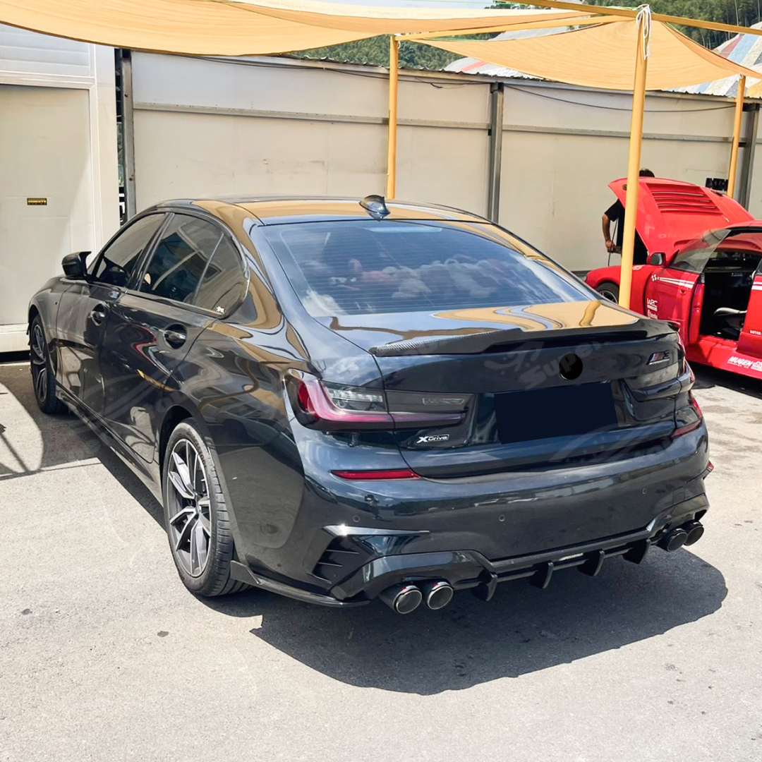 Rear view of Fits 2019-2022 BMW G20 showcasing the Gloss Black Rear Diffuser with LED Brake Light & Corner Splitters, emphasizing aerodynamic improvements