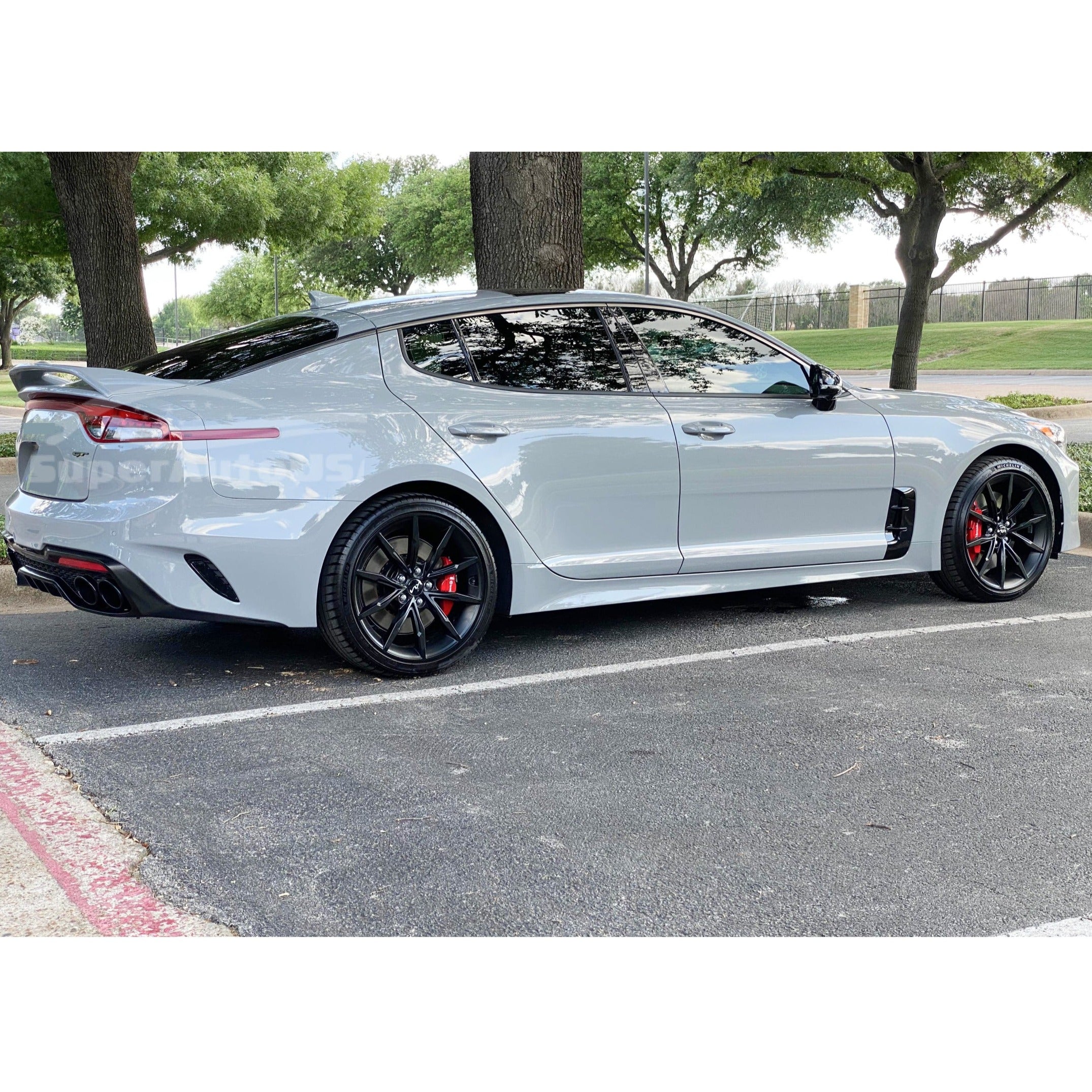 Low angle perspective of the Kia Stinger 2018-2023 with Ceramic Silver Metallic Scorpion GT Style Trunk Upper Spoiler Wing, enhancing the vehicle’s sporty stance