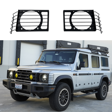 Stainless steel front light guard grilles installed over the headlights on a 2024 INEOS Grenadier Trialmaster Edition