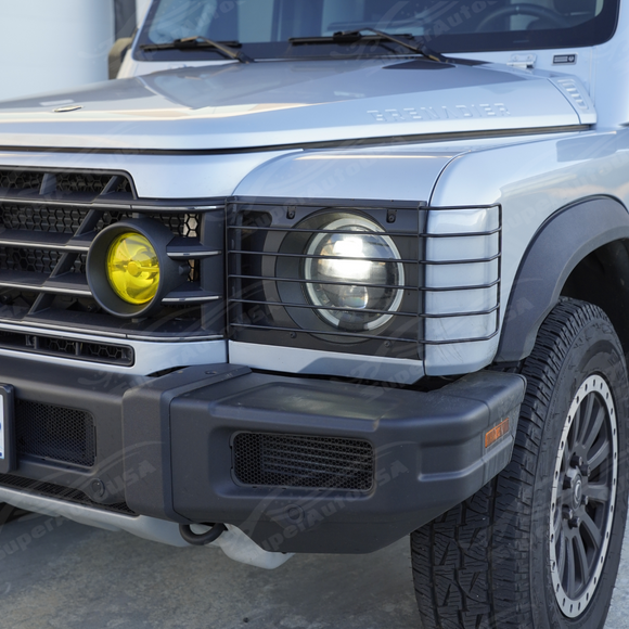Track and trail perspective highlighting the protective stainless steel light guards on an expedition-ready Grenadier