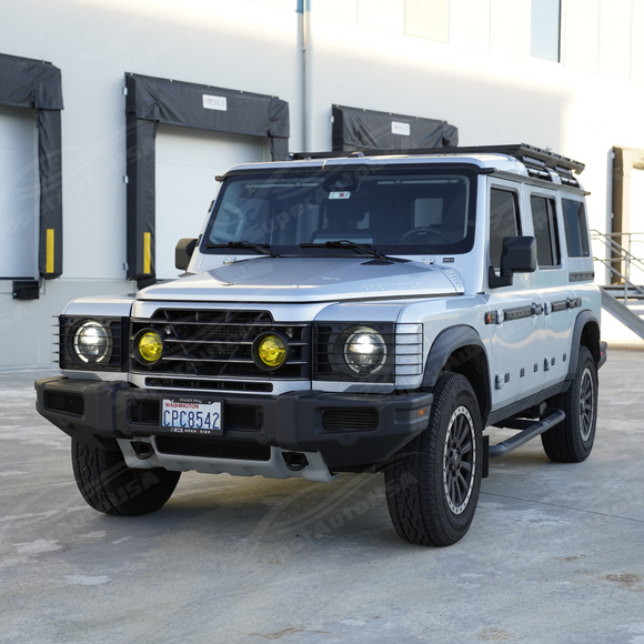 Industrial stainless steel headlight guards providing contrast on a Donny Grey INEOS Grenadier station wagon