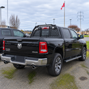 Direct rear view showing high-mounted LED chase lights and rear cab window protection screen on a RAM truck
