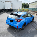 Rear spoiler wing integrated on a blue Subaru Impreza RS