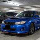 Classic World Rally Blue Subaru STI with the SuperAutoUSA gloss black and red trim front lip