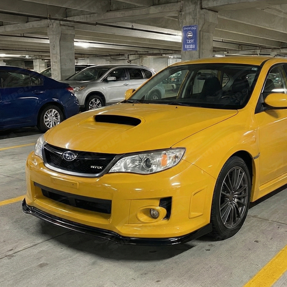 Full 3/4 view of a 2012 Subaru WRX STI with the gloss black front lip kit