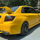 Aggressive carbon print rear side window louvers installed on a 2013 Subaru WRX STI sedan