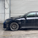 Side perspective emphasizing the deep aerodynamic profile of the front bumper air ducts