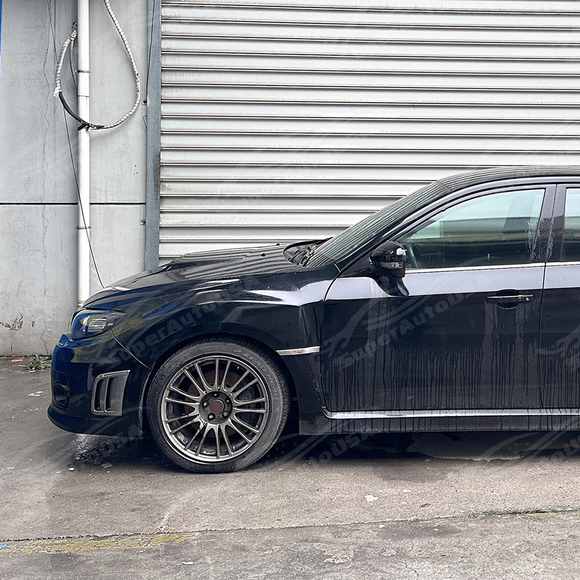 Side perspective emphasizing the deep aerodynamic profile of the front bumper air ducts