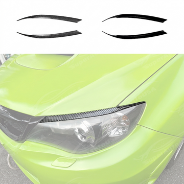 Pair of matte black headlight eyelid overlays installed on a 2011 Subaru WRX STI GV