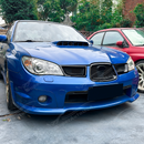 Close-up showing the precision fitment of the center grill overlay over the factory Subaru badge housing