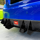 Low-profile shot showing the vertical alignment of the gloss black shark fins on the VA bumper