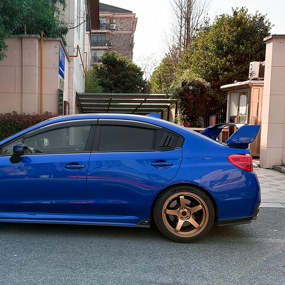 Full rear 3/4 view of a Subaru WRX VA featuring gloss black side window louvers