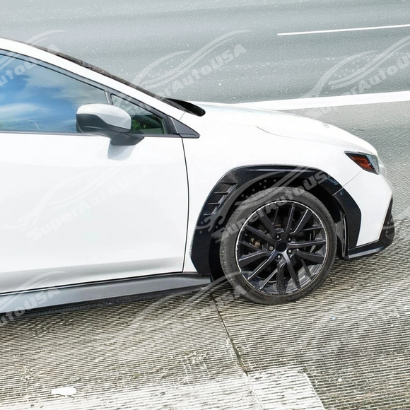 Glossy real carbon fiber front fender flares contrasting sharply with the white paint of a 2023 Subaru WRX VB