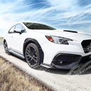 A close-up of the high-gloss real carbon fiber weave on the rear fender flares for the 2021-2025 Subaru WRX
