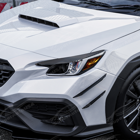 Carbon print headlight eyelid overlays installed on a 2022 Subaru WRX VB