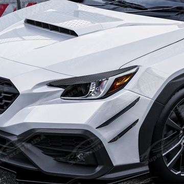 Carbon print headlight eyelid overlays installed on a 2022 Subaru WRX VB
