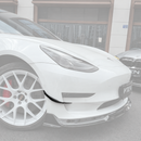 SuperAutoUSA gloss black VTEN style front bumper canards installed on a 2017-2023 Tesla Model 3