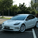 Track-inspired front fascia view of the VTEN canards paired with an aftermarket front lip on a Model 3 Performance