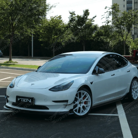 Track-inspired front fascia view of the VTEN canards paired with an aftermarket front lip on a Model 3 Performance