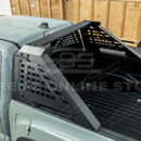 Adjustable steel chase rack on a white Toyota Tacoma