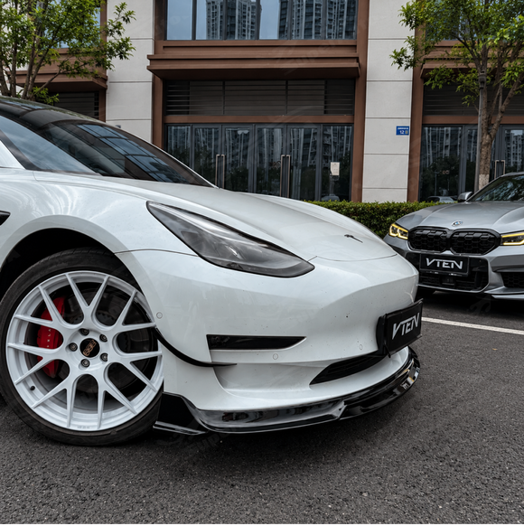 Stealth performance look of the SuperAutoUSA VTEN gloss black 1-piece bumper lip accenting a Solid Black Tesla Model 3