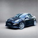 High-gloss black SuperAutoUSA VTEN front lip creating a sharp contrast on a Pearl White Multi-Coat Tesla Model Y