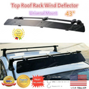 Sleek rooftop wind fairing installed on a vehicle's crossbars