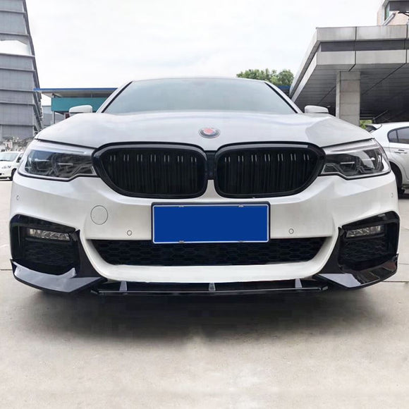 High-contrast motorsport styling of the deep gloss black front splitter mounted on an Alpine White BMW G30